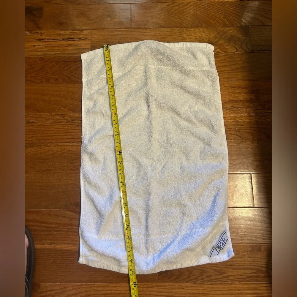 2 sports towels. 1 is reversible and has a tennis player. 1 is izod brand.